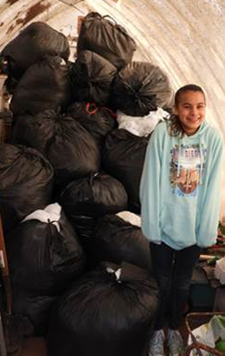 Soami in the green house with bags of bags